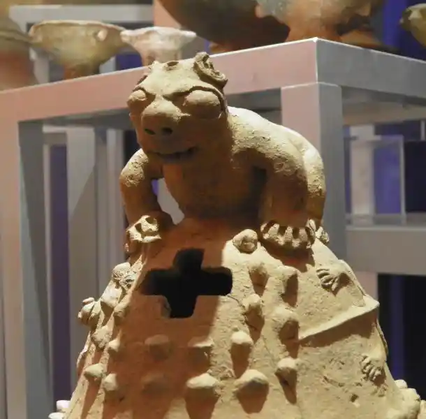 The indigenous cross on ritual pieces, animal on top